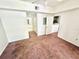Bedroom featuring neutral walls and carpet, with a glimpse into an adjoining bathroom and kitchen at 315 Grand Magnolia Ave # 112, Celebration, FL 34747