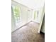 A bright bedroom with carpet and lots of natural light from the three large windows and white walls at 315 Grand Magnolia Ave # 112, Celebration, FL 34747