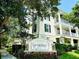 Beautiful exterior of a building with a Georgetown sign in front of the building surrounded by flowers at 315 Grand Magnolia Ave # 112, Celebration, FL 34747