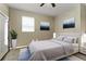 Tastefully decorated bedroom featuring a comfortable bed, artwork, and natural light from a window at 36300 Grand Island Oaks Cir, Grand Island, FL 32735