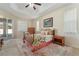 Comfortable bedroom with tray ceiling, fan, and soft carpet, creating a peaceful retreat at 36300 Grand Island Oaks Cir, Grand Island, FL 32735