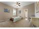 Cozy bedroom featuring neutral tones, carpeted floor, ceiling fan, and natural light at 36300 Grand Island Oaks Cir, Grand Island, FL 32735