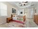 Cozy bedroom features a floral bedspread and a decorative ceiling fan at 36300 Grand Island Oaks Cir, Grand Island, FL 32735