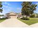 Well maintained home with a spacious driveway and beautiful mature landscaping in a suburban neighborhood at 36300 Grand Island Oaks Cir, Grand Island, FL 32735