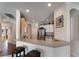 Partial view of the Kitchen, revealing lots of storage and an island with bar stool seating at 36300 Grand Island Oaks Cir, Grand Island, FL 32735