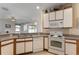Bright kitchen boasts white appliances, plenty of counter space, and opens to the living area at 36300 Grand Island Oaks Cir, Grand Island, FL 32735