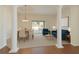 Bright living room with columns, neutral carpet, and a dining area, perfect for entertaining at 36300 Grand Island Oaks Cir, Grand Island, FL 32735