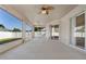 Covered patio with ceiling fan and view of backyard and sliding glass doors for indoor/outdoor living at 36300 Grand Island Oaks Cir, Grand Island, FL 32735