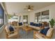 Outdoor patio with comfortable seating, ceiling fans, and view of backyard and table with seating at 36300 Grand Island Oaks Cir, Grand Island, FL 32735