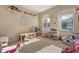 Bright playroom featuring natural light, carpet flooring, and ample space for activities at 36300 Grand Island Oaks Cir, Grand Island, FL 32735