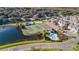 Aerial view of community amenities including tennis courts, pool, playground, pond, and residences at 4011 Venetian Bay Dr # 103, Kissimmee, FL 34741