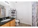 Bathroom features a vanity with granite countertop, wood-look flooring, and a shower with curtain at 4011 Venetian Bay Dr # 103, Kissimmee, FL 34741