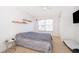 Well-lit bedroom featuring neutral carpet, a window with blinds, and overhead lighting at 4011 Venetian Bay Dr # 103, Kissimmee, FL 34741