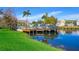 Waterfront view showcasing dock, outdoor furniture, and residences with lush landscaping at 4011 Venetian Bay Dr # 103, Kissimmee, FL 34741