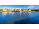 Waterfront view showcasing residences with a fountain and scenic walking path at 4011 Venetian Bay Dr # 103, Kissimmee, FL 34741