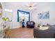 Bright living room features wood floors, ceiling fan and a sunny window with modern furniture at 4011 Venetian Bay Dr # 103, Kissimmee, FL 34741