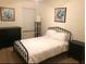 Bedroom featuring neutral decor and a wrought iron bed at 4126 Hedge Maple Pl, Winter Springs, FL 32708