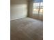 Bright bedroom featuring a large window, neutral walls, and plush carpeting at 4126 Hedge Maple Pl, Winter Springs, FL 32708