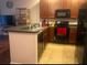 Well-equipped kitchen with bar seating, tile floor and stainless-steel appliances at 4126 Hedge Maple Pl, Winter Springs, FL 32708