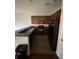 Functional kitchen with essential appliances, dark countertop and ample cabinet space at 4126 Hedge Maple Pl, Winter Springs, FL 32708