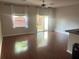 Bright living room featuring hardwood floors and sliding glass doors to outdoor area at 4126 Hedge Maple Pl, Winter Springs, FL 32708
