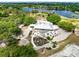 Aerial view of the clubhouse and the golf course overlooking the lake and the neighborhood at 421 Thomez Ct, Lake Mary, FL 32746