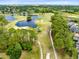 Picturesque aerial view of a golf course winding around a serene lake and luxury homes in the distance at 421 Thomez Ct, Lake Mary, FL 32746