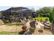 Outdoor firepit with seating in landscaped backyard next to a screened patio at 421 Thomez Ct, Lake Mary, FL 32746