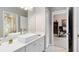 Modern bathroom with a white vessel sink, marble countertop, and a glimpse into an adjacent office space at 421 Thomez Ct, Lake Mary, FL 32746