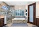 Bathroom boasts a double sink vanity, a soaking tub with tile surround, and a glass enclosed shower at 421 Thomez Ct, Lake Mary, FL 32746