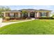 Charming single-story home with a well-manicured lawn, mature landscaping, and inviting entrance at 421 Thomez Ct, Lake Mary, FL 32746