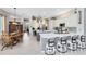 Bright kitchen boasts white cabinets, marble countertops, stainless appliances, an island, and an eat-in dining table at 421 Thomez Ct, Lake Mary, FL 32746