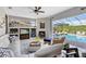Comfortable living room has ample seating, a fireplace and beautiful views of the pool and lanai at 421 Thomez Ct, Lake Mary, FL 32746