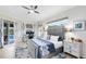 Spacious main bedroom has a seating area, a ceiling fan, and access to the pool area at 421 Thomez Ct, Lake Mary, FL 32746