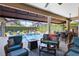 Relaxing outdoor patio featuring comfortable seating, a fire pit, and a view of the sparkling pool at 421 Thomez Ct, Lake Mary, FL 32746
