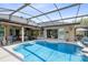 The pool area with summer kitchen connects to the home through sliding glass doors at 421 Thomez Ct, Lake Mary, FL 32746