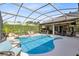 Gorgeous screened pool with water feature, outside bar and multiple seating areas at 421 Thomez Ct, Lake Mary, FL 32746