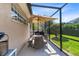 Cozy screened patio with dining furniture and a view of the well-maintained backyard at 421 Thomez Ct, Lake Mary, FL 32746