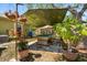 Backyard featuring a covered pool table area with lush greenery and decorative hanging plants for outdoor entertainment at 4371 Vestawood Ct, Sanford, FL 32773