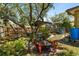 Landscaped backyard featuring a custom fire pit, greenery, and hanging plants for a relaxing outdoor experience at 4371 Vestawood Ct, Sanford, FL 32773