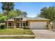 Charming single-story home with mature landscaping, a large driveway, and a two-car garage at 4371 Vestawood Ct, Sanford, FL 32773