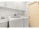 Laundry room features white washer and dryer and lots of cabinet space at 4371 Vestawood Ct, Sanford, FL 32773