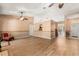 Open-concept living room with wood floors, natural lighting, and access to the kitchen and front entry at 4371 Vestawood Ct, Sanford, FL 32773