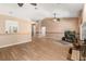 Spacious living area with wood flooring, ceiling fan, and an open layout for seamless entertaining at 4371 Vestawood Ct, Sanford, FL 32773