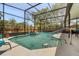Swimming pool is surrounded by a screened enclosure and lush landscaping at 4371 Vestawood Ct, Sanford, FL 32773