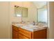 The bathroom features a double sink vanity and a large mirror at 4522 Weeping Willow Cir, Casselberry, FL 32707