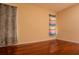Simple bedroom with hardwood floors, two windows, and light-colored walls at 4522 Weeping Willow Cir, Casselberry, FL 32707