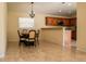Open-concept dining area with tile floors, chandelier lighting, and a partial view into the kitchen at 4522 Weeping Willow Cir, Casselberry, FL 32707