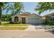 Charming single-story home with a well-maintained lawn, two-car garage, and beautiful mature trees at 4522 Weeping Willow Cir, Casselberry, FL 32707