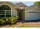 Inviting front entrance with arched window, neutral exterior paint, and a well-manicured lawn at 4522 Weeping Willow Cir, Casselberry, FL 32707